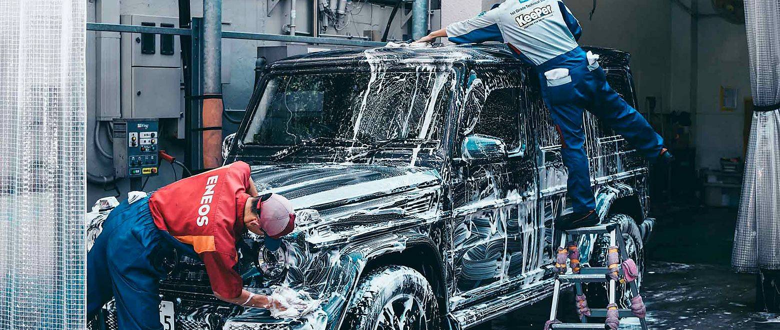 Mechanics washing an SUV in the Northgate workshop